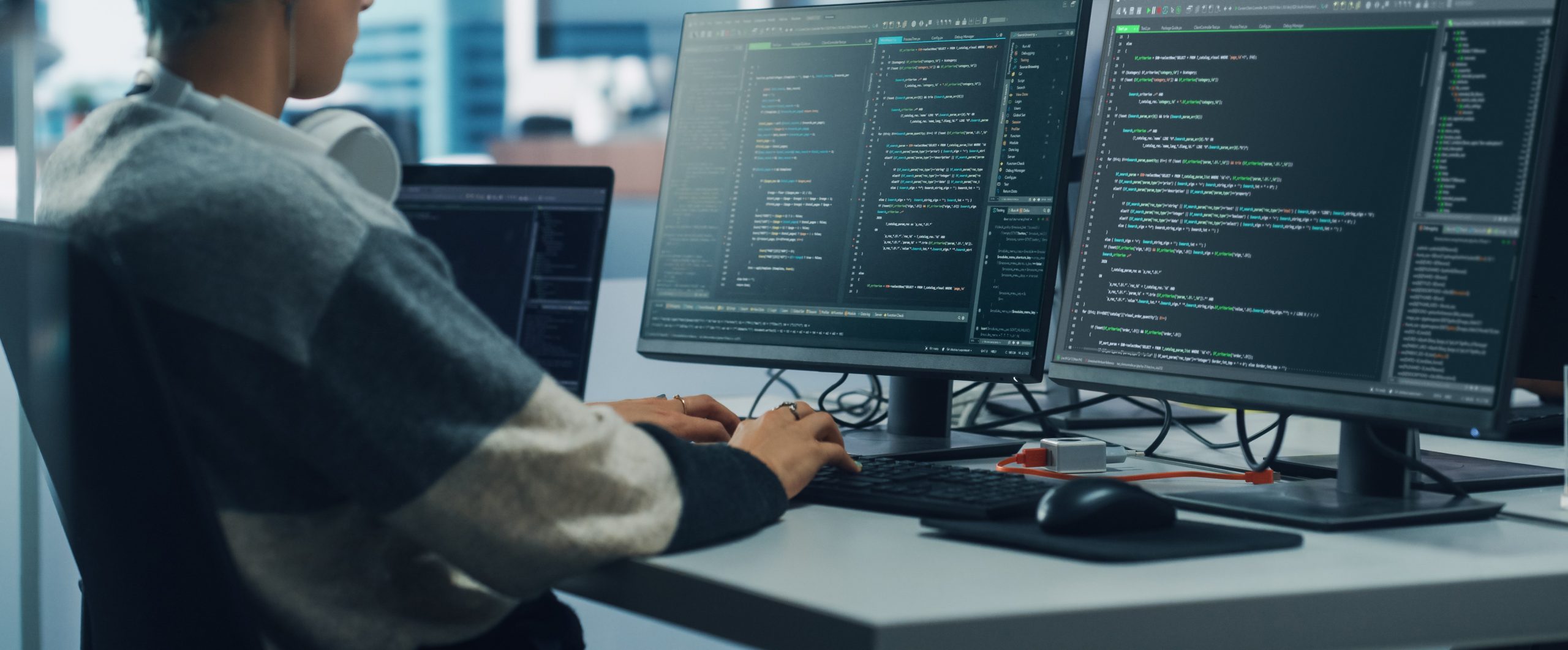 person working on a laptop with code